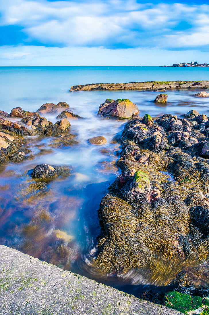 rocks in ocean water with cloudy background during daytime, ireland, ireland