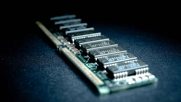 green and black RAM card, closeup photo of a DIMM stick, hardware