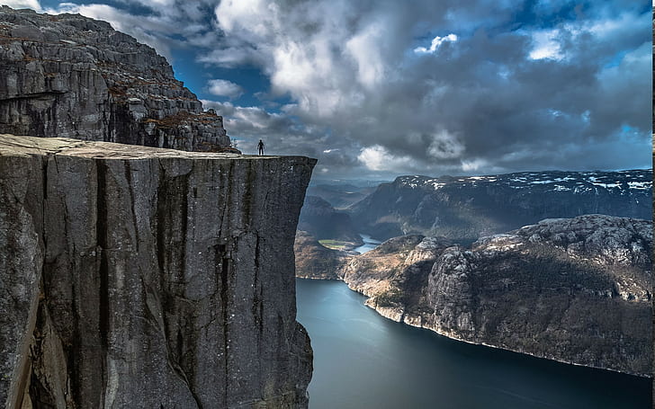 nature landscape fjord alone cliff mountain norway preikestolen sea rock calm water valley europe clouds