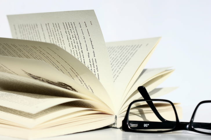 open page book beside black frame eyeglasses, Masculine, Explore