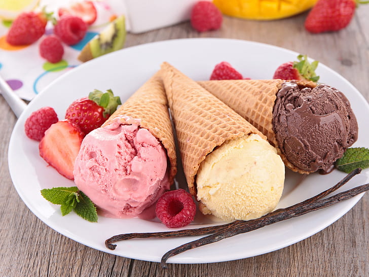 Ice cream, dessert, stawberry, vanilla and chocolate ice cream in cone with cinnamon sticks and slice strawberry fruits