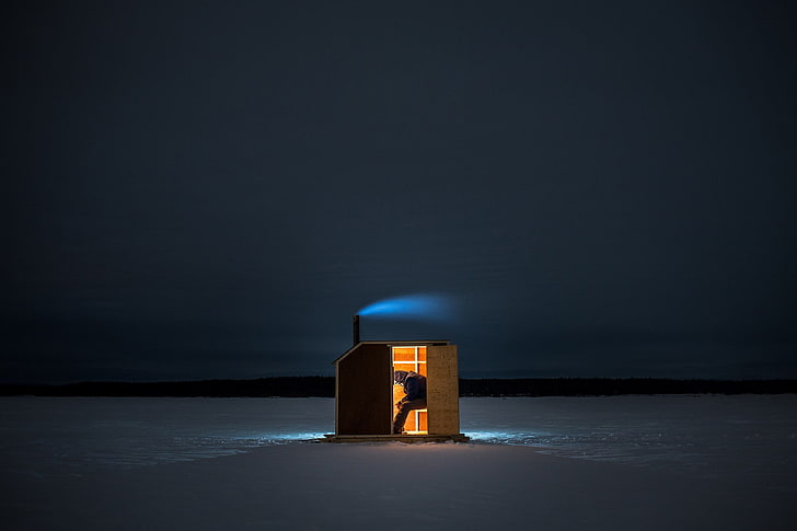 brown wooden shed in middle of snowfield, people, night, landscape