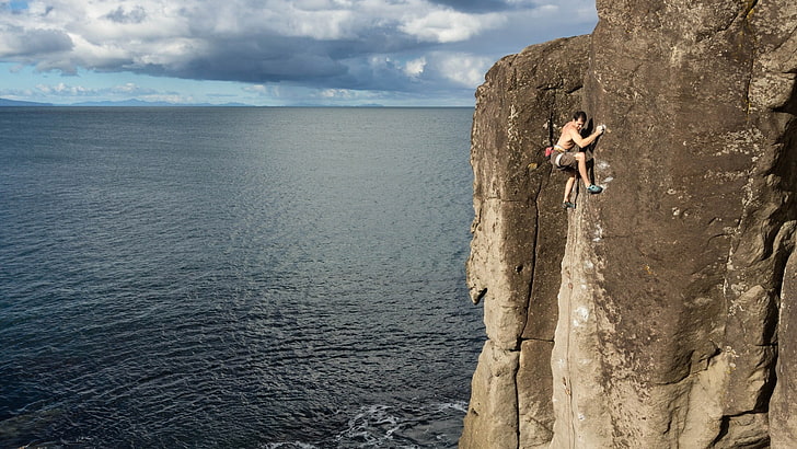 brown rocky mountain, climbing, rock climbing, sea, water, one person, HD wallpaper
