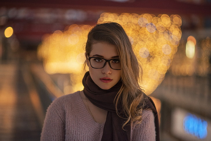 clear eyeglasses with black frames, woman wears brown scoop-neck knitted top