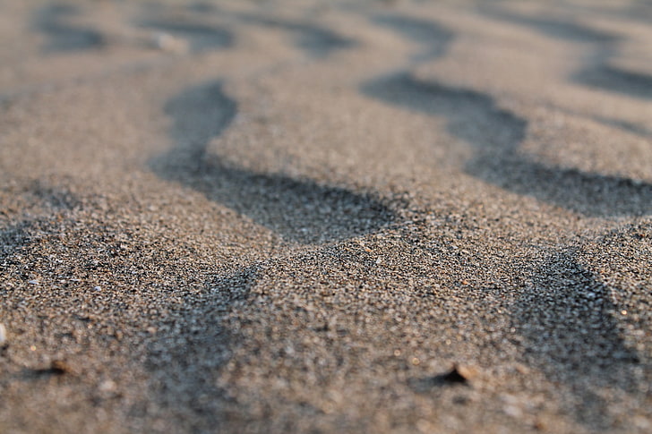 gray sand, closeup photo of sand, macro, tilt shift, blurred
