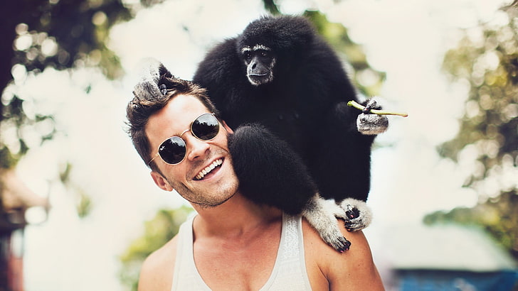 men's white tank top, smiling, sunglasses, animals, monkey, bokeh