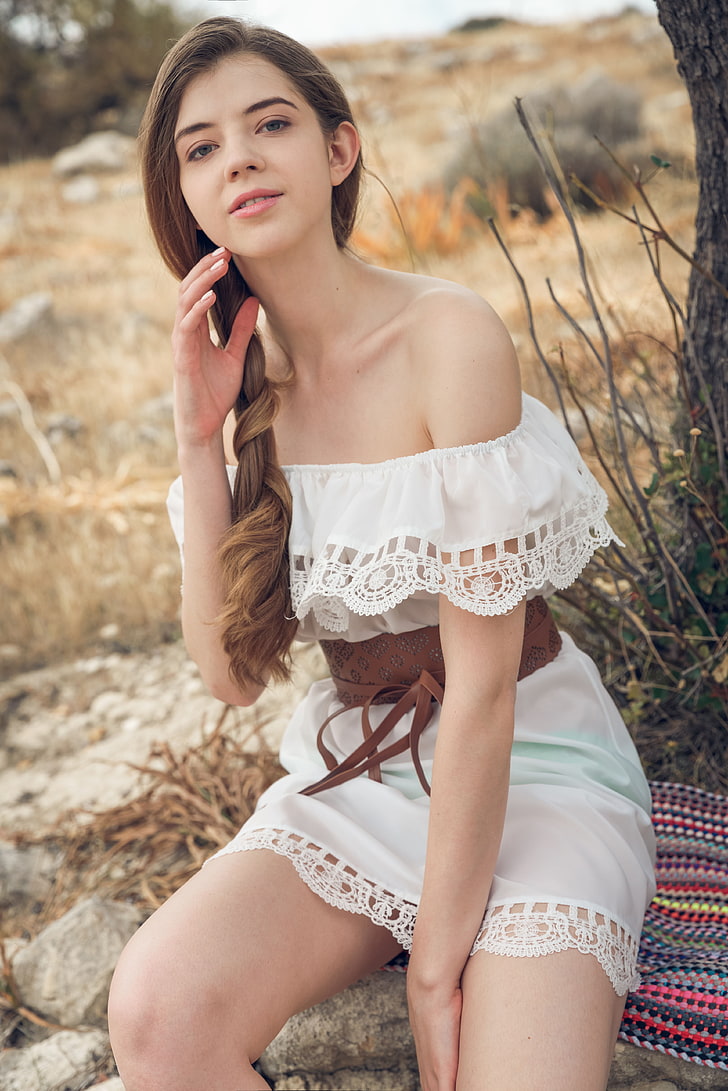 Kay J, model, women outdoors, white dress, bare shoulders, touching face