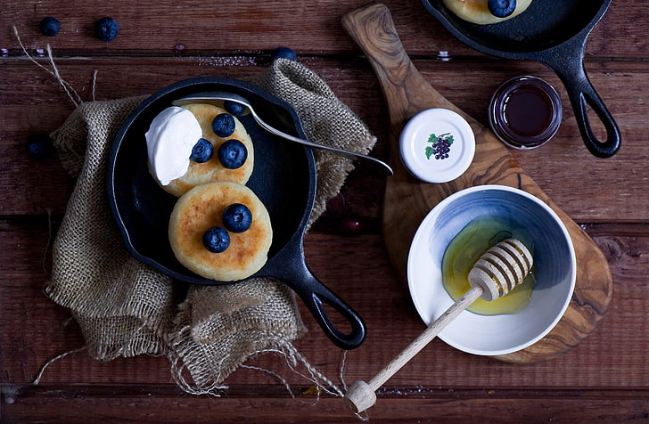 cast iron skillet and honey with dip, pancakes, fruit, bowl, blueberries