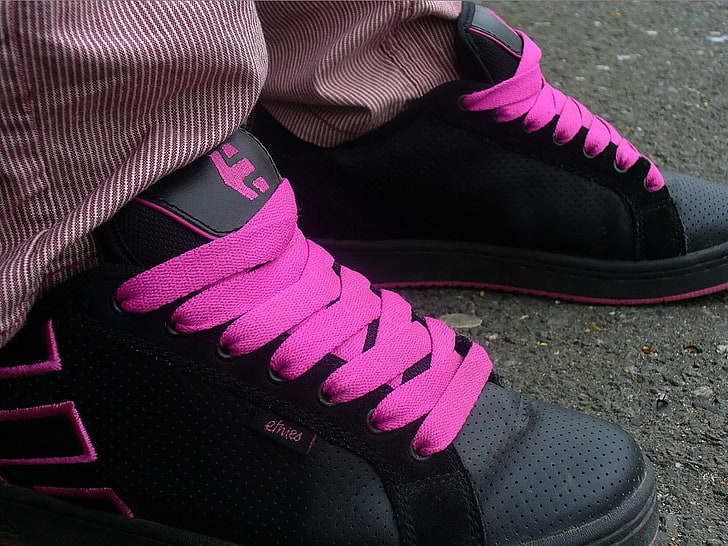 pair of black-and-pink Nike basketball shoes, human leg, low section