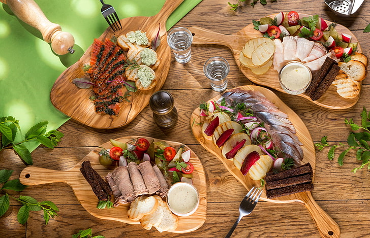cooked food and brown wooden boards, fish, bread, meat, vodka