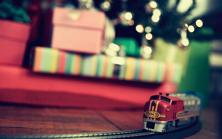 selective focus photography of red and gray train, red and gray toy train on brown wooden surface