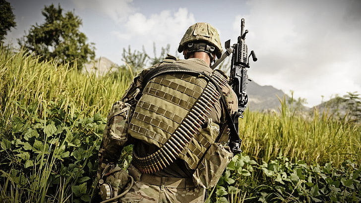 man wearing brown backpack holding rifle on green grass field, HD wallpaper