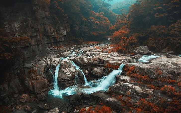 waterfalls surrounded by rocks, landscape photo of waterfalls
