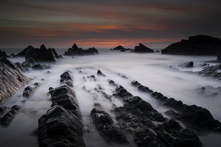timelapse photography of rocky mountain covered by sea of clouds during sunset, hartland quay, hartland quay