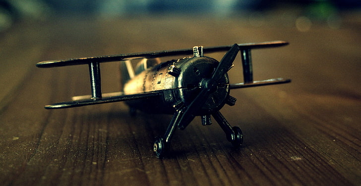 shallow photo of propeller plane toy on table, macro, airplane