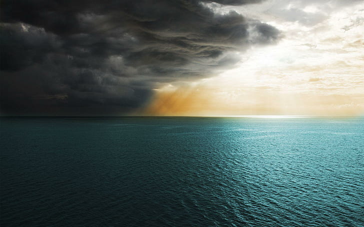 Storm clouds covering the sun, body of water and dark clouds