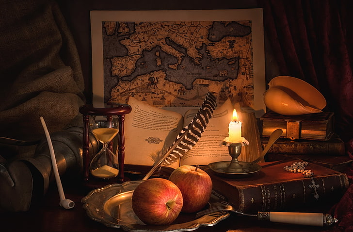 two red apples, pen, books, map, candle, tube, shell, still life