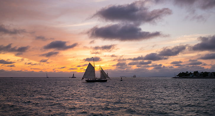 boats at the ocean near island during sunset, key west, key west