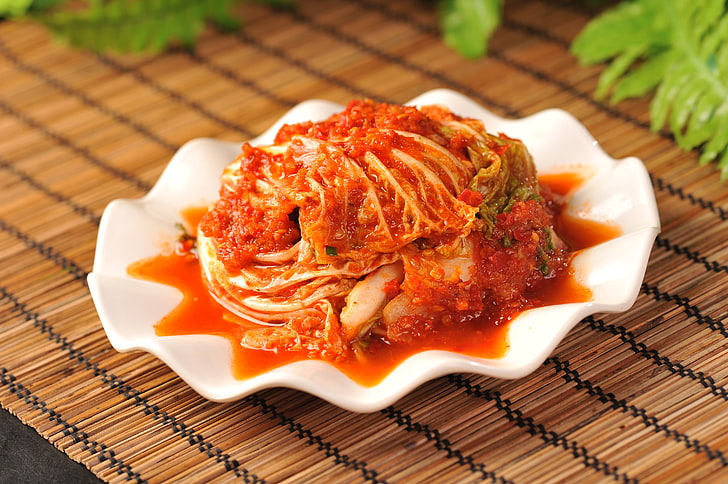 cooked food and white ceramic saucer, hot sauce, korean kimchi