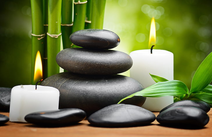 two white candles and marble stones, bamboo, leaves, Spa stones