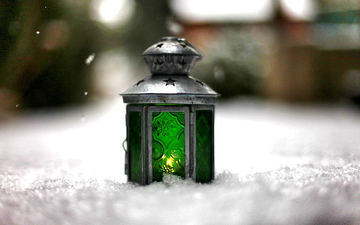 gray metal and green glass wax warmer on ice snow in selective focus photography