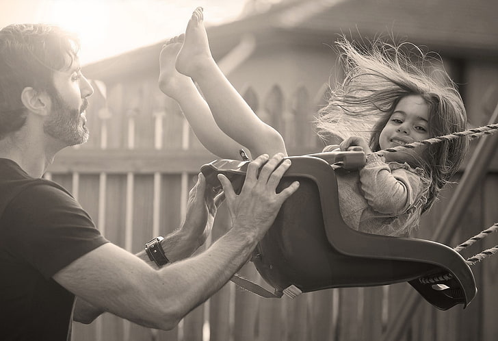 man swinging child on swing grayscale photography, joy, children