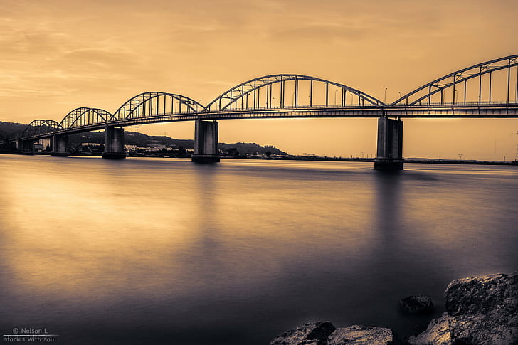 silhouette photo of concrete bridge above calm body of water, portugal, portugal