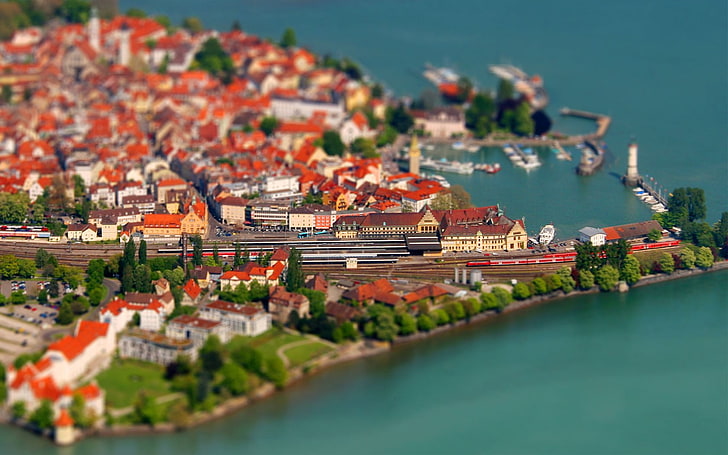 selective focus aerial photography of city near body of water