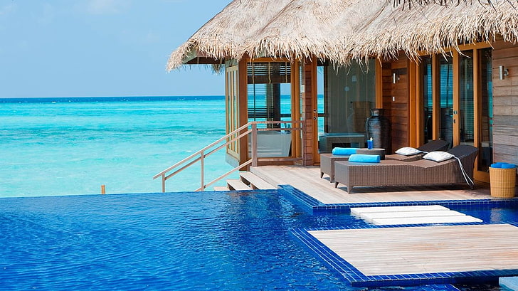brown wooden floating cottage, Maldives, resort, swimming pool