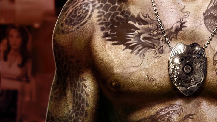 person with dragon body tattoo wearing silver-colored pedant necklace