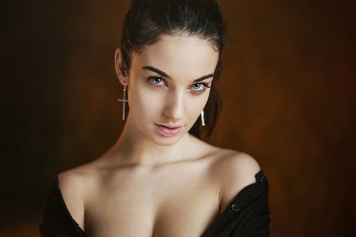 women's gold-colored cross pendant earrings, Alla Berger, model