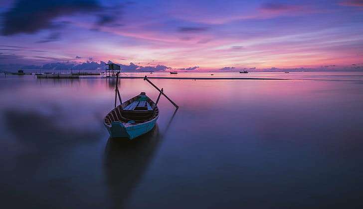 photography of gray canoe on body of water under purple sky during daytime, vietnam, vietnam