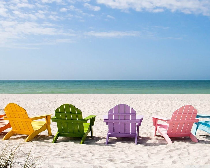 yellow, green, purple, and pink wooden adirondack chairs, deck chairs