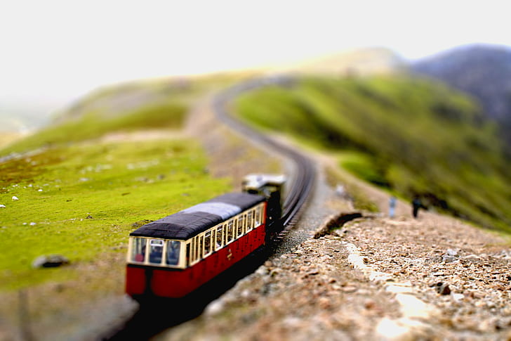 tilt shift photo of red and black train plastic toy, snowdon, snowdon