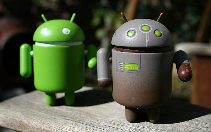 two green and gray Android robot toys, prototype, program, logo