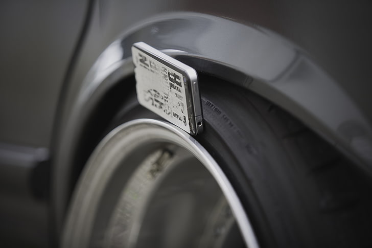 grey car wheel with tire, BMW E28, Squatty, close-up, selective focus