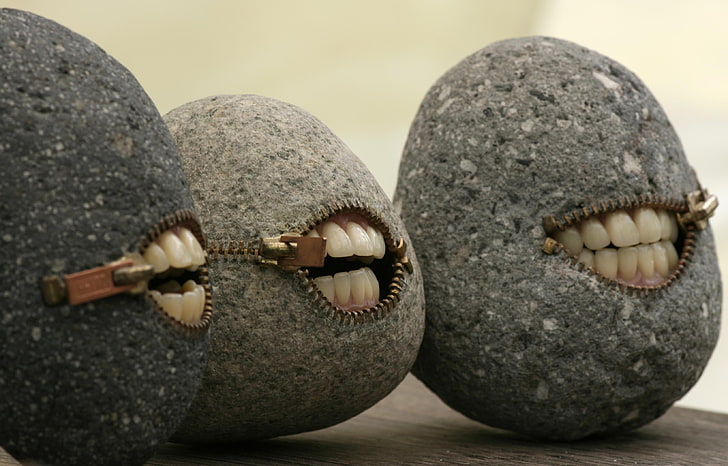 three gray stones with human teeth decors, rock, humor, minimalism