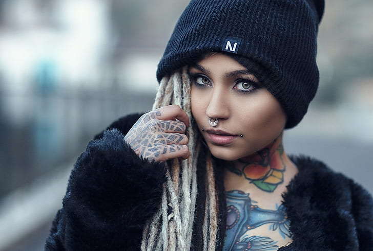 women model face looking at viewer fishball suicide nose rings hat tattoo portrait
