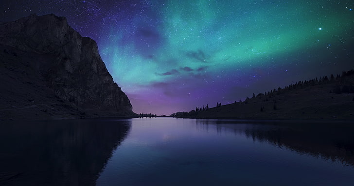 blue body of water, aurora borealis above the body of water beside the mountain