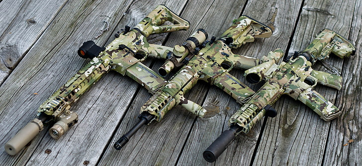 three brown-and-green camouflage assault rifles, wood, scope