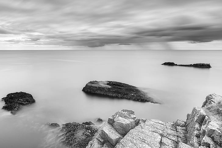 grayscale photography of rocky mountain and body of water, Out to Sea