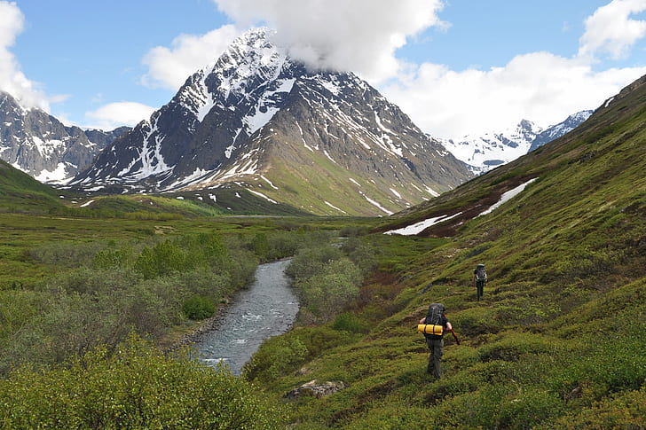 photo of two persons traveling in a mountain during day time, alaska, alaska