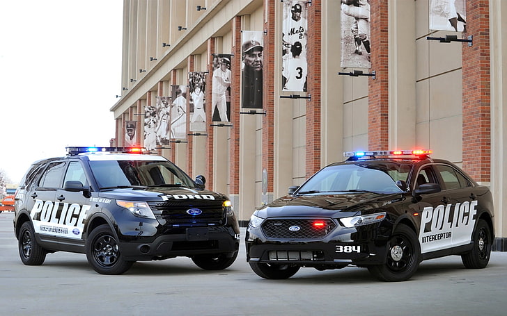 black Ford Taurus sedan and black Ford Explorer SUV, police, jeep