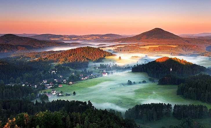 aerial photograph of town, summer, morning, mist, forest, hills
