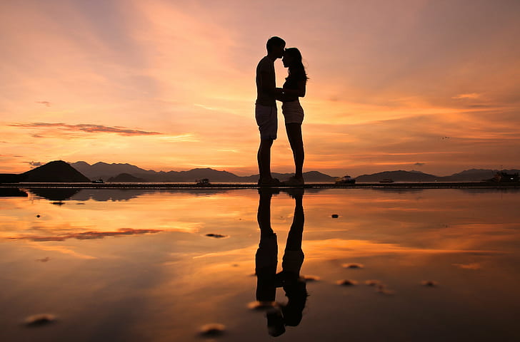 photo of man and woman standing each other, james, sunset, burning love