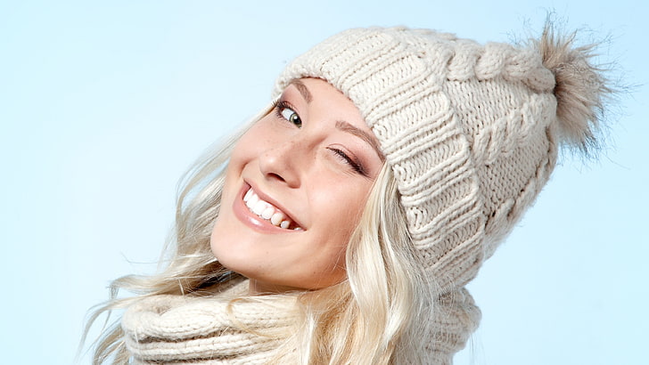 women, woolly hat, winking, smiling, warm clothing, headshot