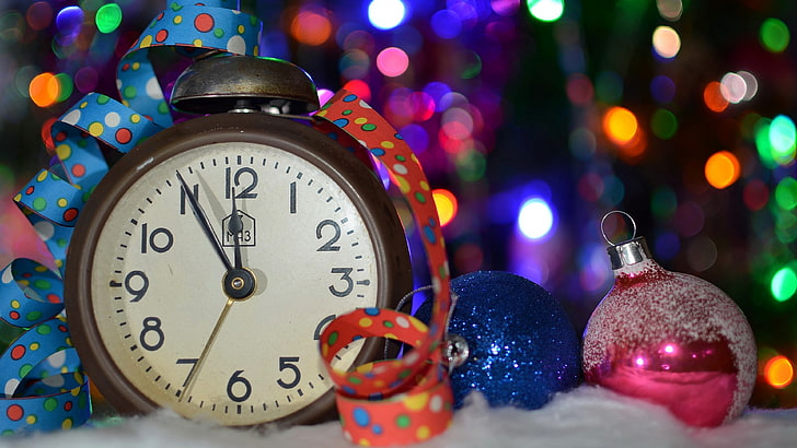 brown ta, round white analog desk clock beside blue and pink baubles, HD wallpaper