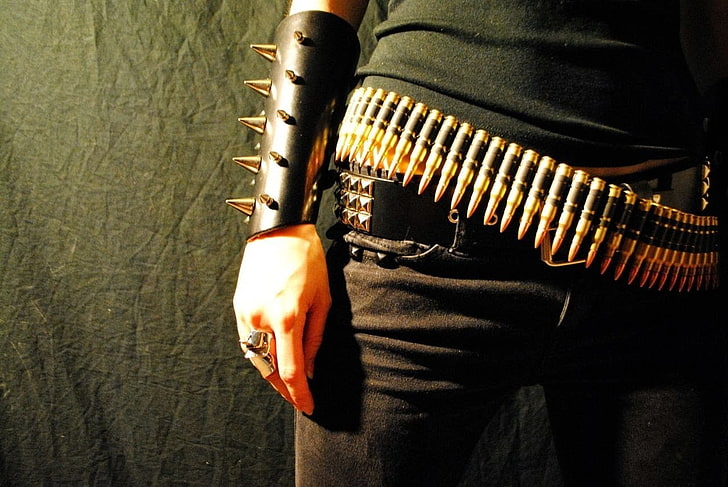 woman wearing black shirt with gray bullet on her belt, metal music