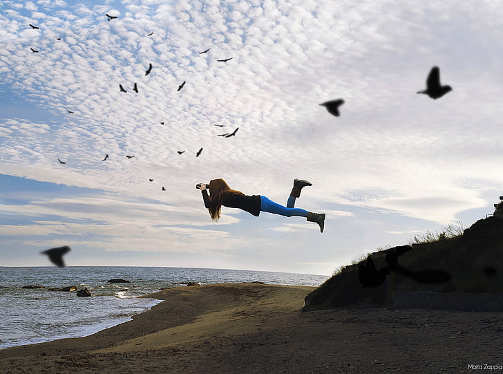 Free, floating woman holding camera in forced perspective photography