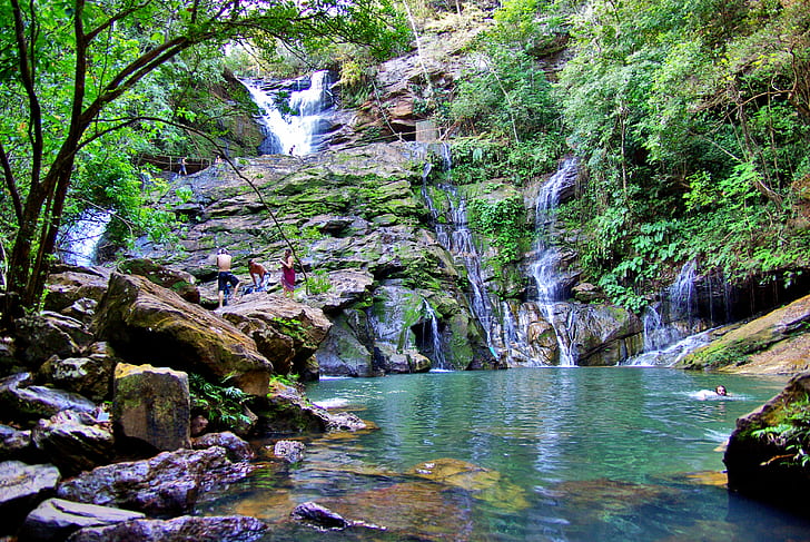 group of people swimming at clear blue waterfalls, cocal, cocal